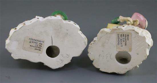 A pair of Rockingham porcelain groups of a shepherd and shepherdess, c.1830, h. 21.5 and 18cm, some faults
